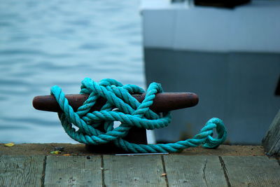 Close-up of turquoise rope tied on cleat