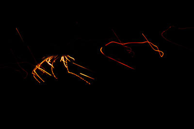 Close-up of light painting against black background