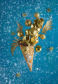 Close-up of christmas decorations over blue background