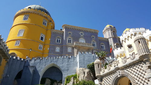 Low angle view of temple against clear blue sky