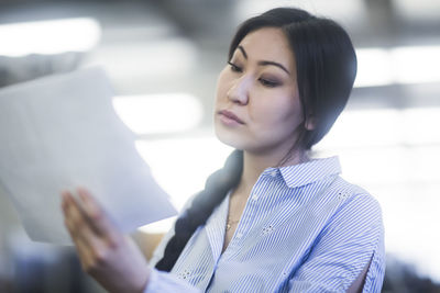 Young asia woman with paper in an office concentrate