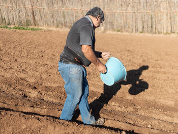 Side view of man working on farm