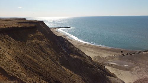 Plateau by blue sea against clear sky