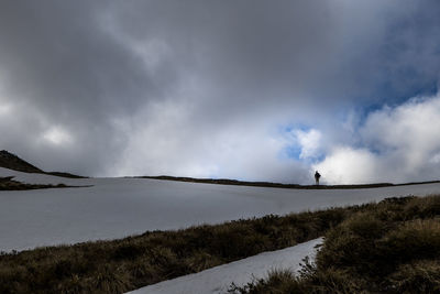 Figure on a ridge, in the snowy alpine mountains of new zealand