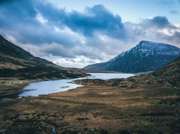 Scenic view of lake and mountains against sky
