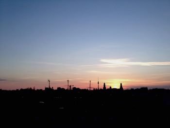 Silhouette built structure at sunset