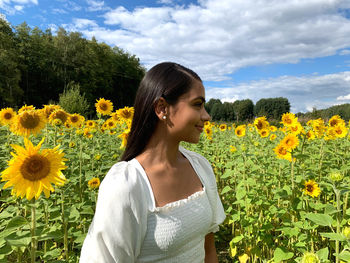 Woman standing in front of sunflower