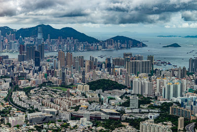 Aerial view of buildings in city against sky