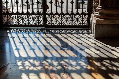 Shadow of railing on staircase of building