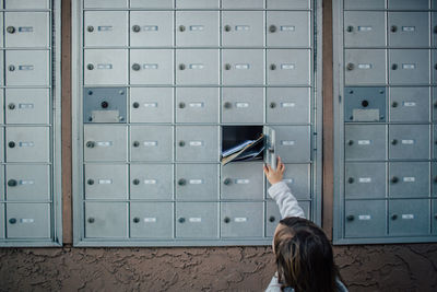 Child unlocks and opens door to cluster mailbox unit
