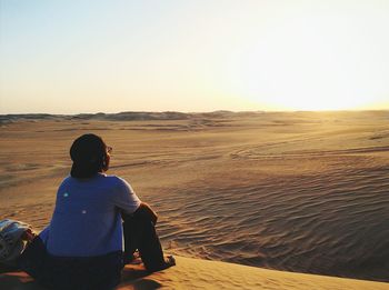 Woman standing on landscape against clear sky