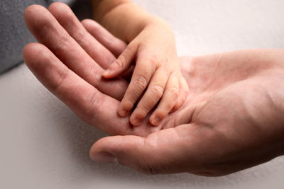 Cropped image of couple holding hands