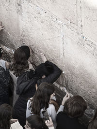 Rear view of people on wall