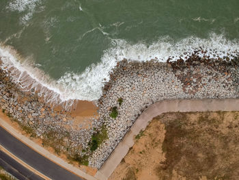 Aerial view of road by sea
