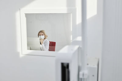 Radiologist wearing protective face mask working in clinic