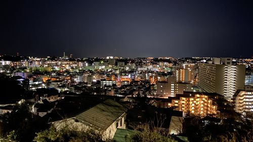 High angle view of illuminated buildings in city at night