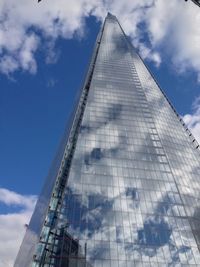 Low angle view of communications tower against sky