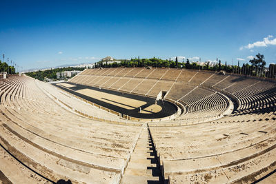 Scenic view of stadium against blue sky