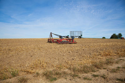 Traditional windmill on field against sky