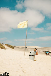 People on beach against sky