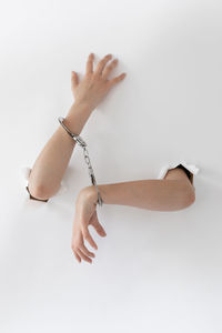 Close-up of woman hand against white background