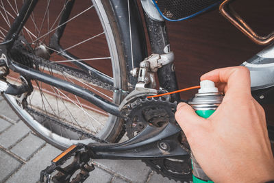 Cropped hand of man repairing bicycle