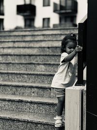 Rear view of woman standing against wall