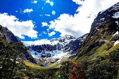 Scenic view of mountains against cloudy sky