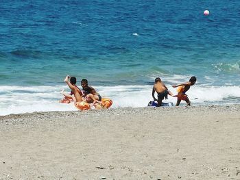 People playing on beach