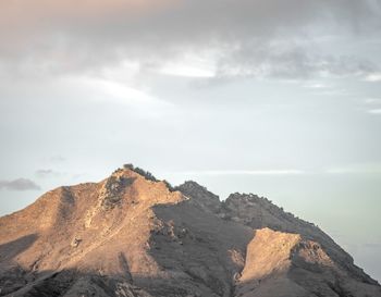 Rock formations on mountain against sky