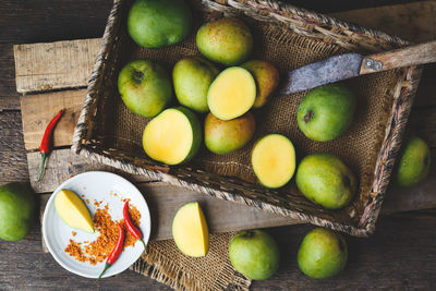 High angle view of fruits in basket on table