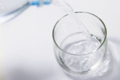 Close-up of water in glass against white background