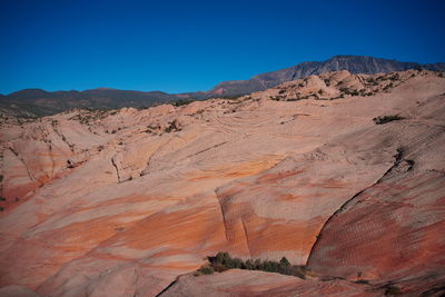 Scenic view of mountains against clear blue sky