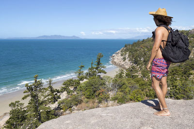 Woman looking at sea against sky