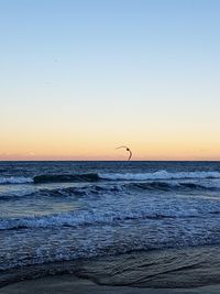 Scenic view of sea against clear sky during sunset