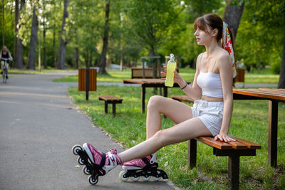 Side view of woman exercising in park