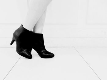 Low section of woman standing on tiled floor