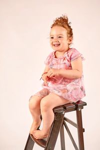 Young woman looking away over white background