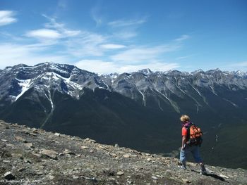 Rear view of hiker walking on mountain