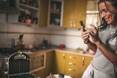 Man using mobile phone at home