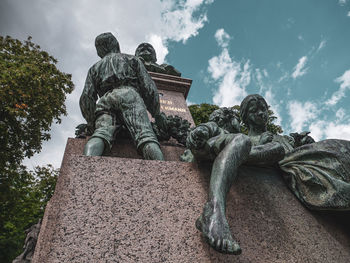 Low angle view of statue in park against sky