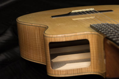 High angle view of guitar on bed