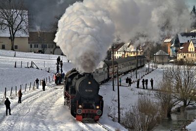 Panoramic view of snow covered steam- lokomotive against sky during winter