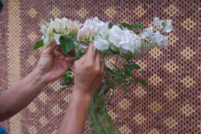 Midsection of woman holding bouquet