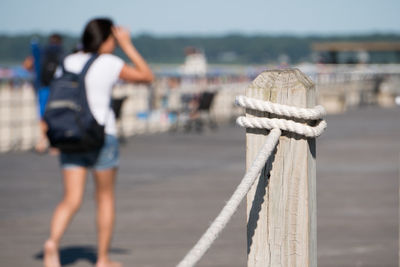 Rear view of women standing at sea shore