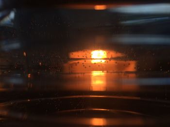 View of illuminated car window during rainy season