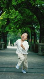 Asian boy running outdoors