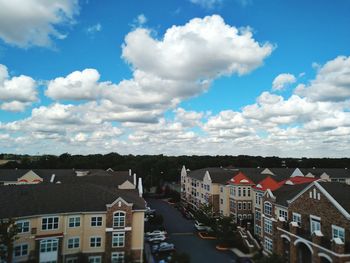 High angle view of houses against cloudy sky