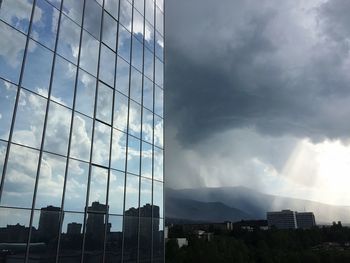 Low angle view of buildings against cloudy sky
