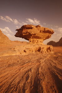 Low angle view of rock formation against sky during sunny day